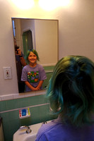 F in the mirror with her fancy green hair