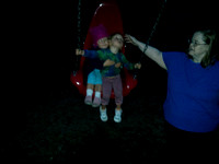 JA pushing both babies on a big red swing!