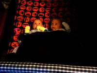 F and K in the playpen, watching the lion mobile on 14 Jan 2012