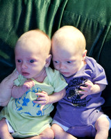 Adorable shirts, cranky babies.  One month old pics.