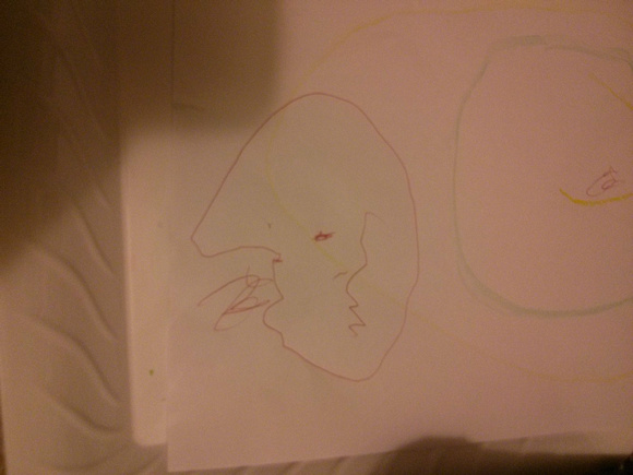 It's a skull!  One of their first pieces of representational art.  We're not sure who drew it.  K says it was her.