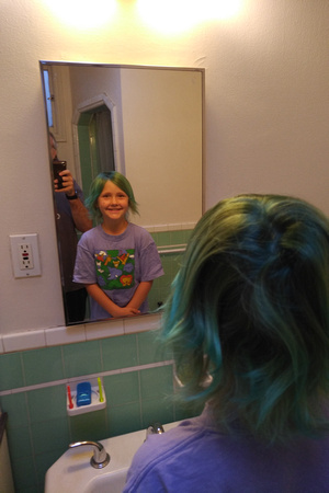 F in the mirror with her fancy green hair