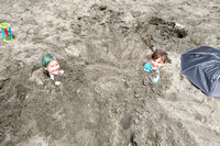 Girls buried up to their neck in the sand