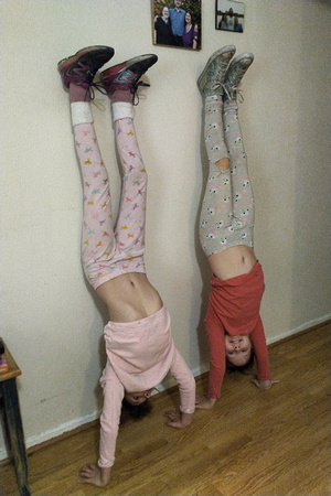 Both girls practicing handstands