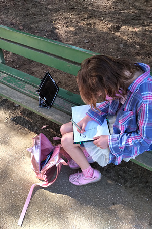 K drawing in her notebook