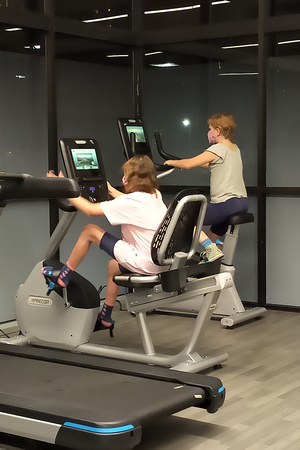 The girls playing on hotel exercise machines