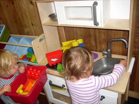 Girls with a play kitchen