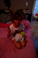 K with her baby Cthulhu in a baby bed she made