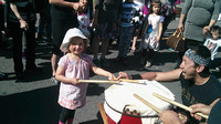 K learning how to drum at a local Japanese festival.