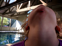 K slipped downwards on a pool ladder and tore a chunk out of her chin on the pavement; ouch.