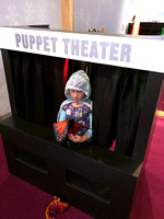 K putting on a puppet show, with dressup.