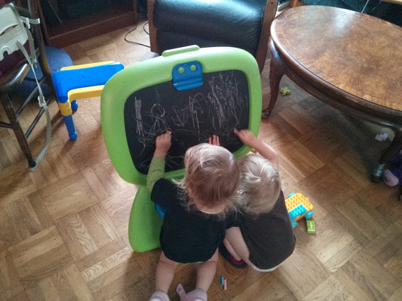 Playing with AJ's birthday present chalkboard.