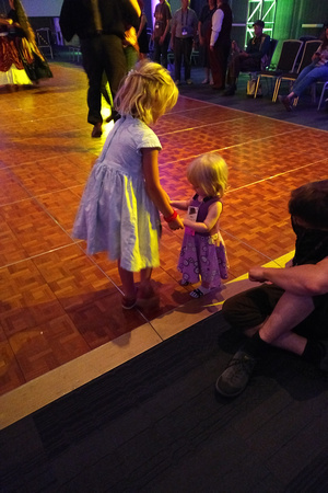F helping a baby dance at Worldcon 76 in San Jose