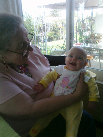 Baby by the window with grandma.