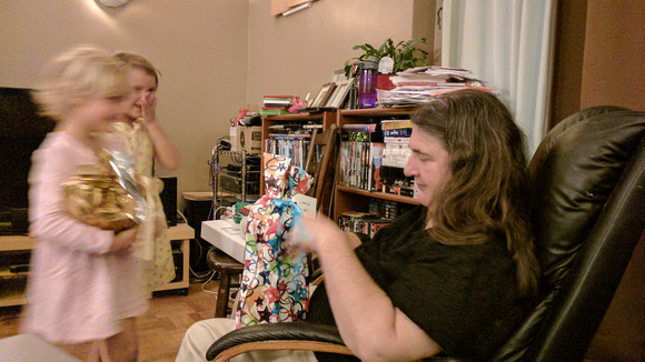 Mommy opening her birthday presents.  1/4