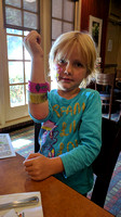 F showing off her bracelet and stickers.