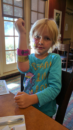 F showing off her bracelet and stickers.