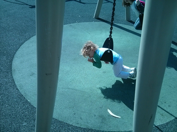 K enjoying a swing by herself.