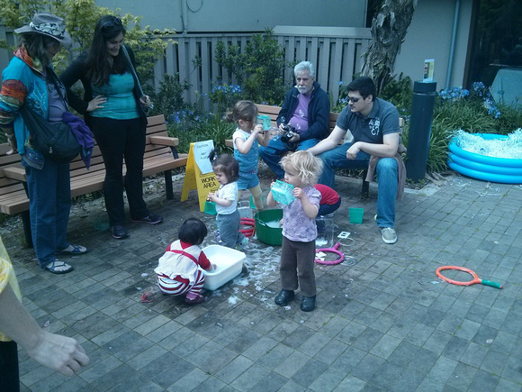Making bubbles with strawberry crates at the Big San Francisco Play Date at the library.