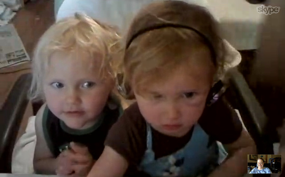 K playing doctor (that's what she calls it when she uses my headset) on Skype.