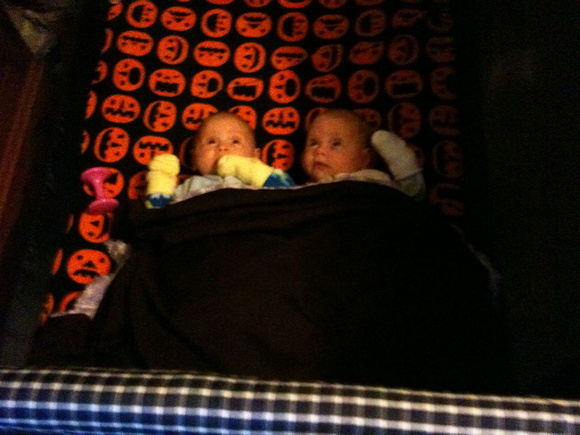 F and K in the playpen, watching the lion mobile on 14 Jan 2012