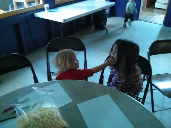 Feeding another kid at Sunday Assembly SF.