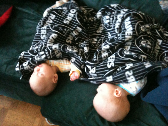 AJ and RA got the babies to sleep during the day not on mommy!  Under a Raiders blankie on the couch, almost 4 months old.