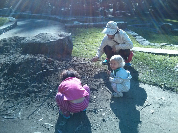 Drawing in the dirt with new friends.