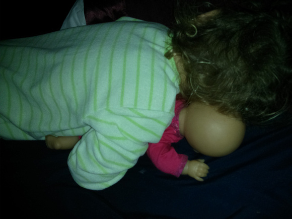 Sleeping with a doll.  :3