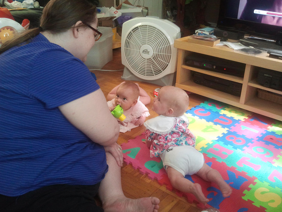 Babies listen attentively to Auntie Jen.